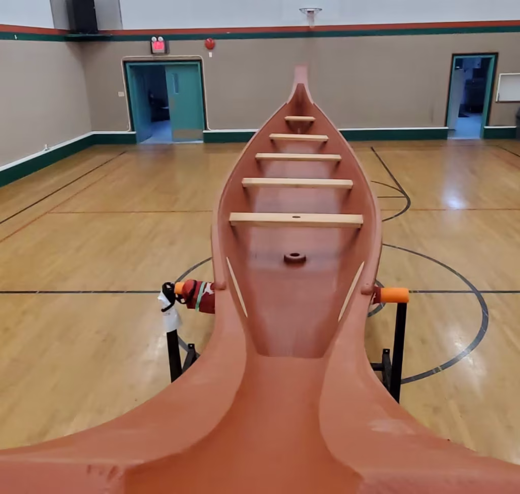 A view looking down the length of an K’ómoks First Nation canoe’s interior.